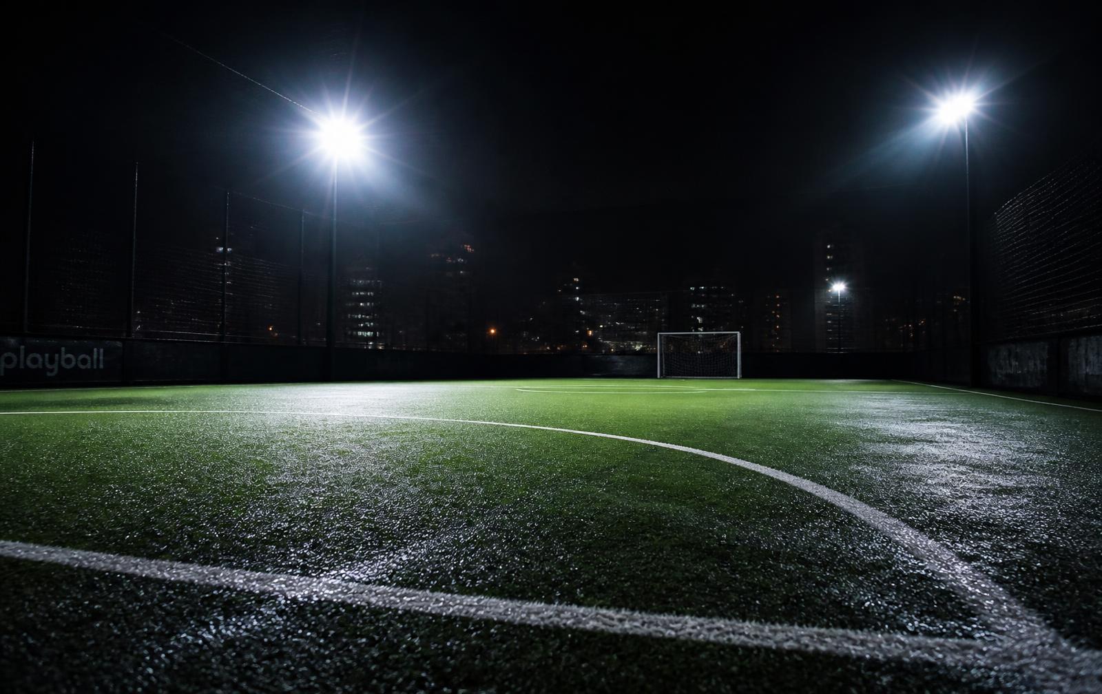 Floodlit football turf at night